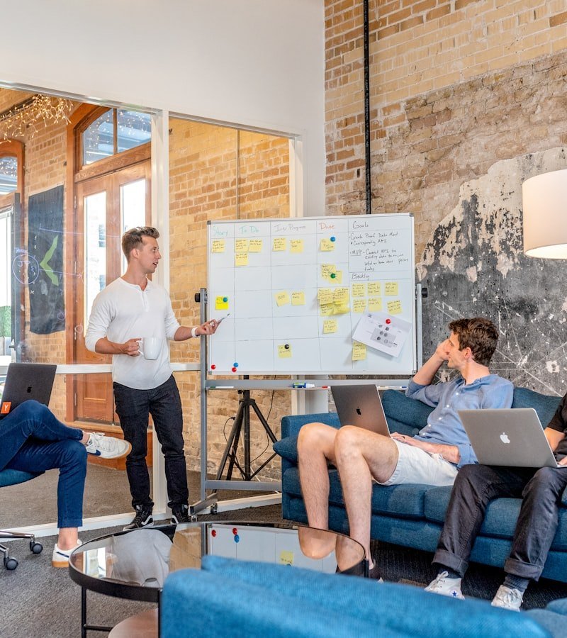 Marketing team reviewing a social campaign on a whiteboard